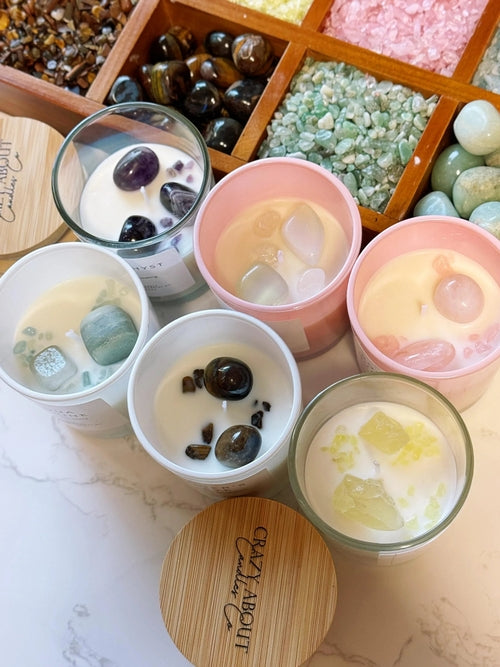 Assorted small containers with various contents on a marble surface, with a wooden lid in the foreground.