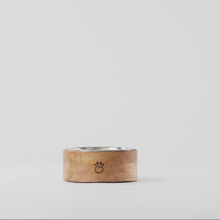 Wooden ring with metal band on a light gray background