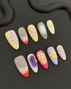 Colorful polly pocket hawaiian kawaii nail art designs on a black background