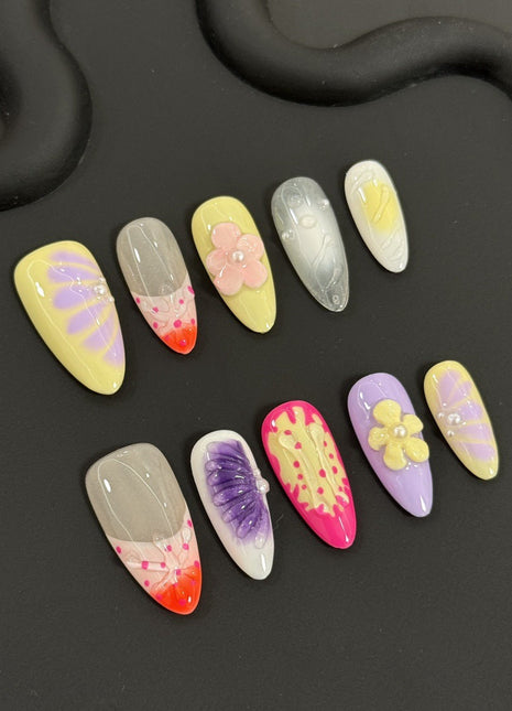 Colorful polly pocket hawaiian kawaii nail art designs on a black background