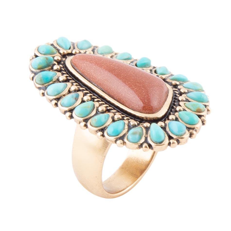 Ring with turquoise stones and a central brown stone on a white background