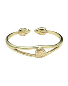 Gold bracelet with leaf designs on a white background